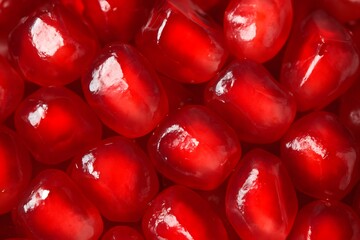 Close Up of Bright Red Pomegranate Seeds with Glossy Surface in Vibrant Colors