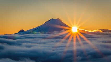 Majestic snow-capped mountain peak at sunrise above clouds