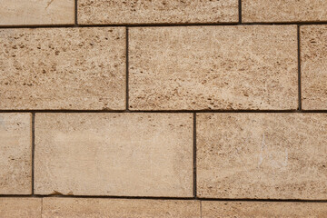 Yellow brick wall texture. House stone wall texture background. Stone wall as background or texture. Part of a stone wall