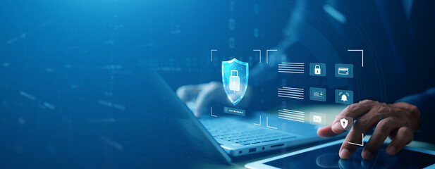 Close-up of hands typing on laptop with digital login interface overlay, username and password fields, and security padlock icon. Concept of cybersecurity and data protection.
