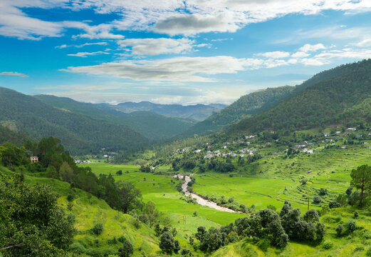 Majestic Green Valley with River and Terraced Fields in Himalayan Mountains under Blue Sky &ndash; Scenic Landscape of Uttarakhand, India