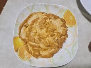 golden Thai omelet in white plate serving on wood table