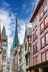 Obraz premium Medieval street lined with half-timbered houses near Rouen Cathedral in Rouen, France showcasing architectural beauty and vivid colors
