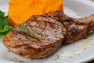 grilled pork loin on a white plate macro photo