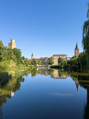 reflection in the pond skyline of the city altenburg with in thuringia east germany vertical