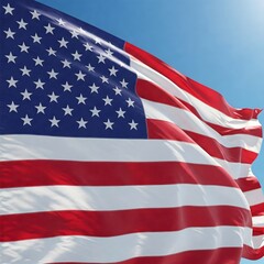 American Flag waving proudly against a bright blue sky, showcasing its vibrant red and white stripes and stars.