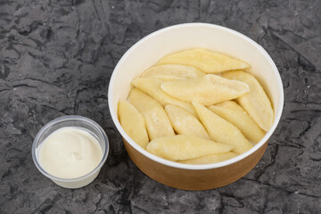 lazy dumplings galushki in disposable dishes photo