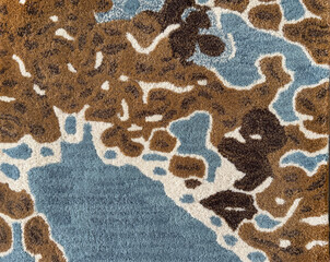Random design with abstract pattern hand tufted carpet texture, in blue, brown, white color. Random wavy washed pattern carpet rug seamless background texture
