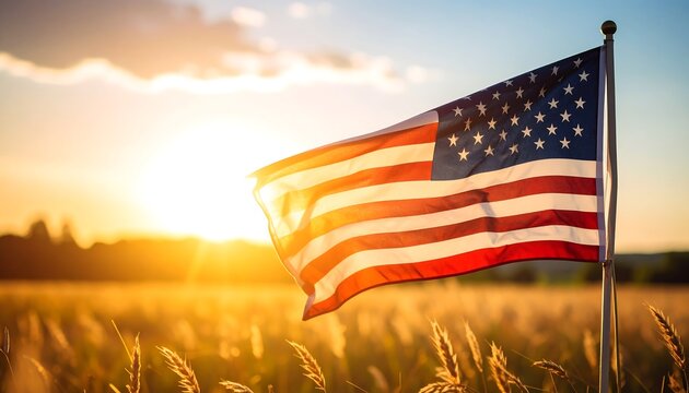 American flag waving in golden field at sunset