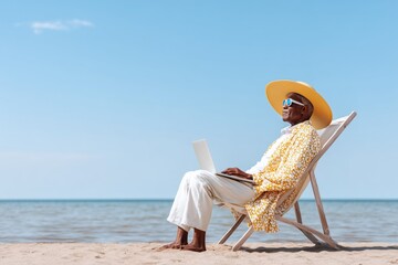 Relaxing on the beach with a laptop in hand while enjoying the sun and sea breeze