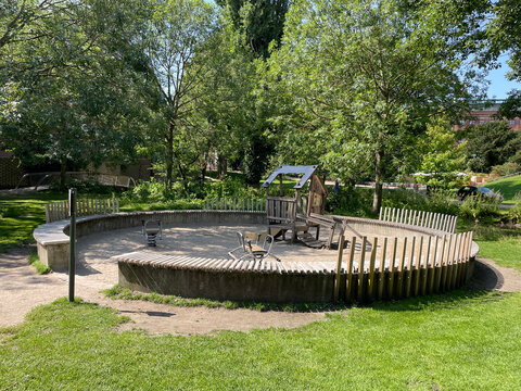 Sunny Outdoor Playground with Wooden Playhouse and Spring Riders in Sandpit Odense, Denmark
