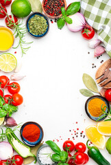 Healthy food cooking frame background with spices, herbs, turmeric, chili powder and kitchen utensils, white table, top view