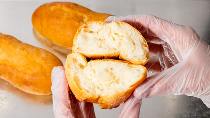 Plastic-gloved hands tear into golden baguettes, evoking French Epiphany traditions and bread-making alchemy, with a fragrant crisp allure