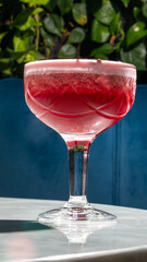 Crimson cocktail in vintage glass, echoing bygone jazz age glamour, perfect for Negroni Week or International Cocktail Day celebration