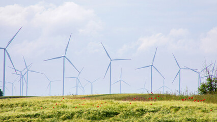 Wind turbines dance under azure skies, celebrating Global Wind Day and Eco-Conscious Creativity amidst poetic, whispering meadows