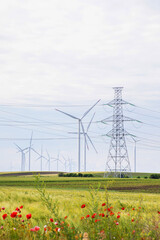 Towering wind turbines dance over verdant fields, a ballet of eco-harmony, embracing Earth Day's...