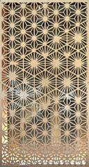 Close up of geometrical hexagon shape pattern carved from plywood. 3D cutout laser cut hexagonal shapes finished in warm bright wood tone. Seamless background texture.