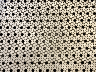 Close up white and black hexagon mosaic tiles pattern. Suitable for wall and floor mosaic tiles, in bathroom or kitchen. Seamless background texture