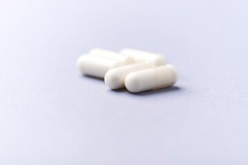 Creatine tablets on paper background. Soft focus. Close up. Copy space.	