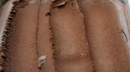 Close-up view of creamy chocolate ice cream showcasing smooth, rich texture with visible scooping marks.