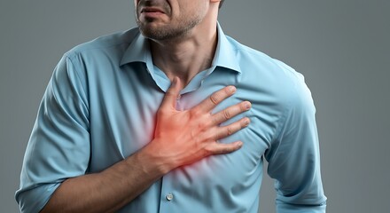 Man experiencing severe chest pain possible heart attack symptom with highlighted red area on chest and suffering expression on his face