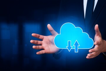 Businessman holding a glowing blue cloud with upload and download arrows
