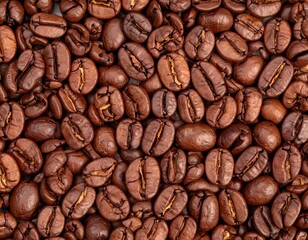 Obraz premium Freshly Roasted Coffee Beans Scattered on a Surface, Showcasing Rich Brown Hues and Textures