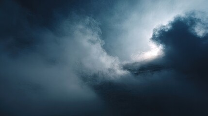 Dramatic cloudscapes, dark and brooding, with a glimpse of light