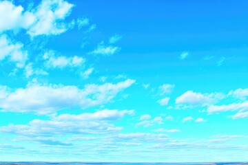 Vibrant blue sky dotted with fluffy white clouds