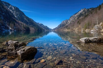Fototapeta premium Serene mountain lake with crystal-clear water reflecting peaks