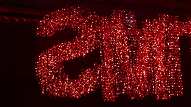 Shiny letters from shimmering sequins on a black background