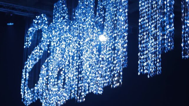 Shiny letters from shimmering sequins on a black background