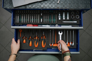 Open toolbox with organized tools in a workshop garage setting