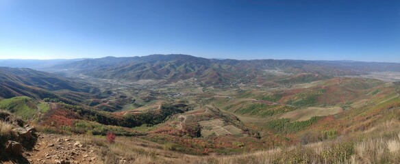 Fototapeta premium Panoramic view of a valley nestled between mountains