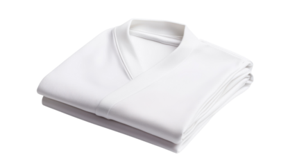 A neatly folded white garment rests on a plain background, emphasizing its simplicity and elegance