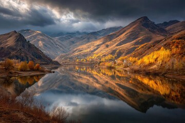 Autumnal mountain lake reflecting golden foliage