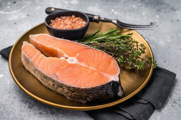 Juicy raw salmon cut, highlighting its natural marbling and freshness. Perfect for grilling or baking to create a mouthwatering meal. grey background. top view