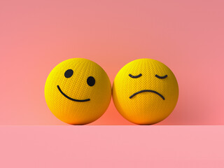 Happy and sad 3D knitted emoji balls with contrast on pink background