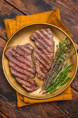 Juicy Denver, chuck eye steak, expertly grilled to perfection, offering a mouthwatering aroma and a deliciously charred exterior. wooden background. top view