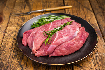 Raw Duck breast fillet slices for stir-fry cooking. wooden background. top view