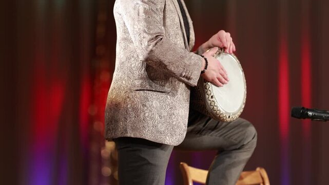 man playing the darbuka drum