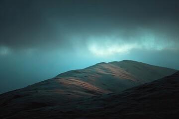 Misty mountain peak bathed in pale light