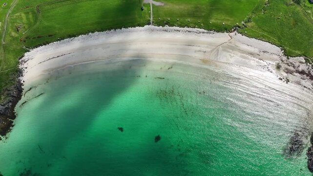 Hov beach in Gims&oslash;y Lofoten with turquoise water, waves, grass and scenic summer coastline