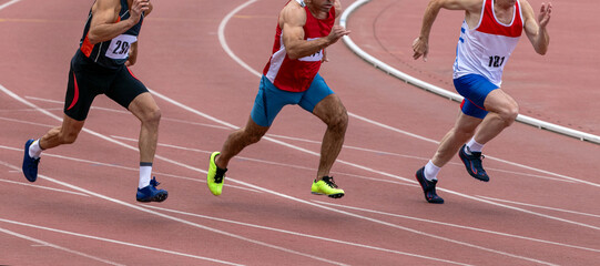 Fototapeta premium Group middle-aged athlete running sprint race during veterans athletics competition