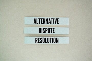 Paper arranged with the words Alternative Dispute Resolution. the term used to describe ways of resolving a dispute without having to go to court.
