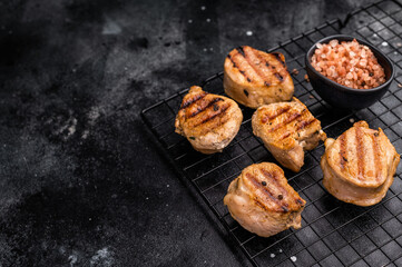 BBQ grilled pork medallions steaks, tenderloin fillet meat. black background. top view