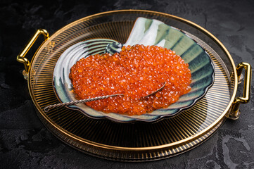 Bright red caviar, a gourmet delight that adds a burst of flavor to any dish or celebration.  grey background. top view