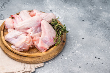 Fresh raw chicken wings, perfect for marinating and grilling, ready to become the star of your next barbecue. grey background. top view