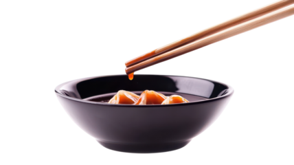 Enjoying the savory taste of dumplings dipped in soy sauce with wooden chopsticks for an authentic flavor