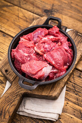 Freshly cut raw beef neck meat, waiting to be seasoned and cooked to perfection for your next culinary creation. wooden background. top view